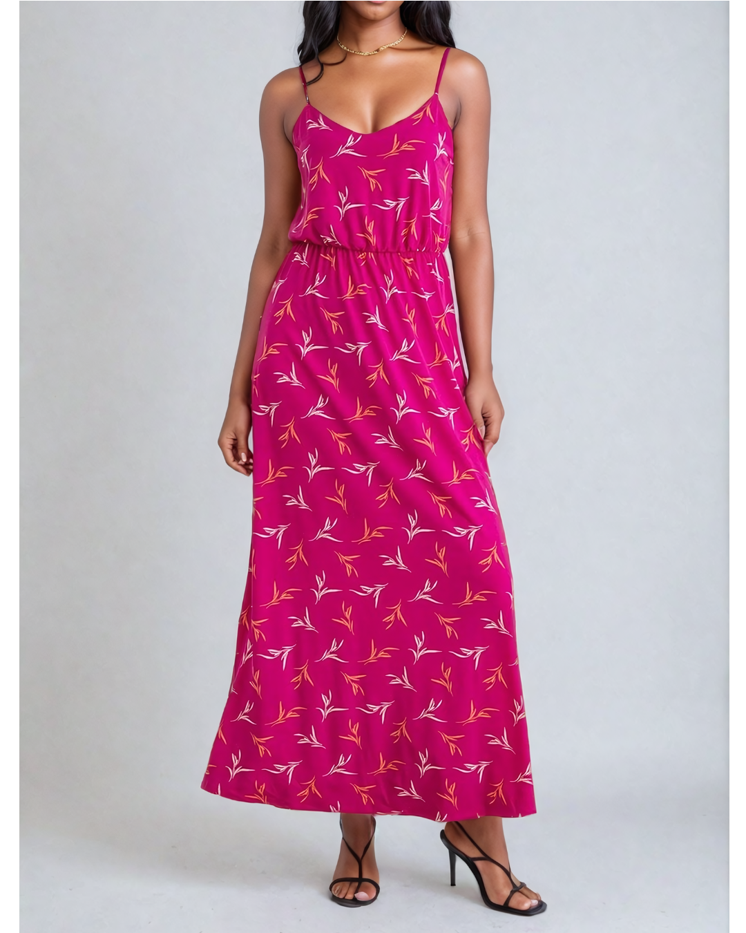 Image of a woman wearing a Fly Away Cami Maxi Dress in a vibrant floral print, suitable for various occasions, with adjustable straps and a flattering cami neckline.