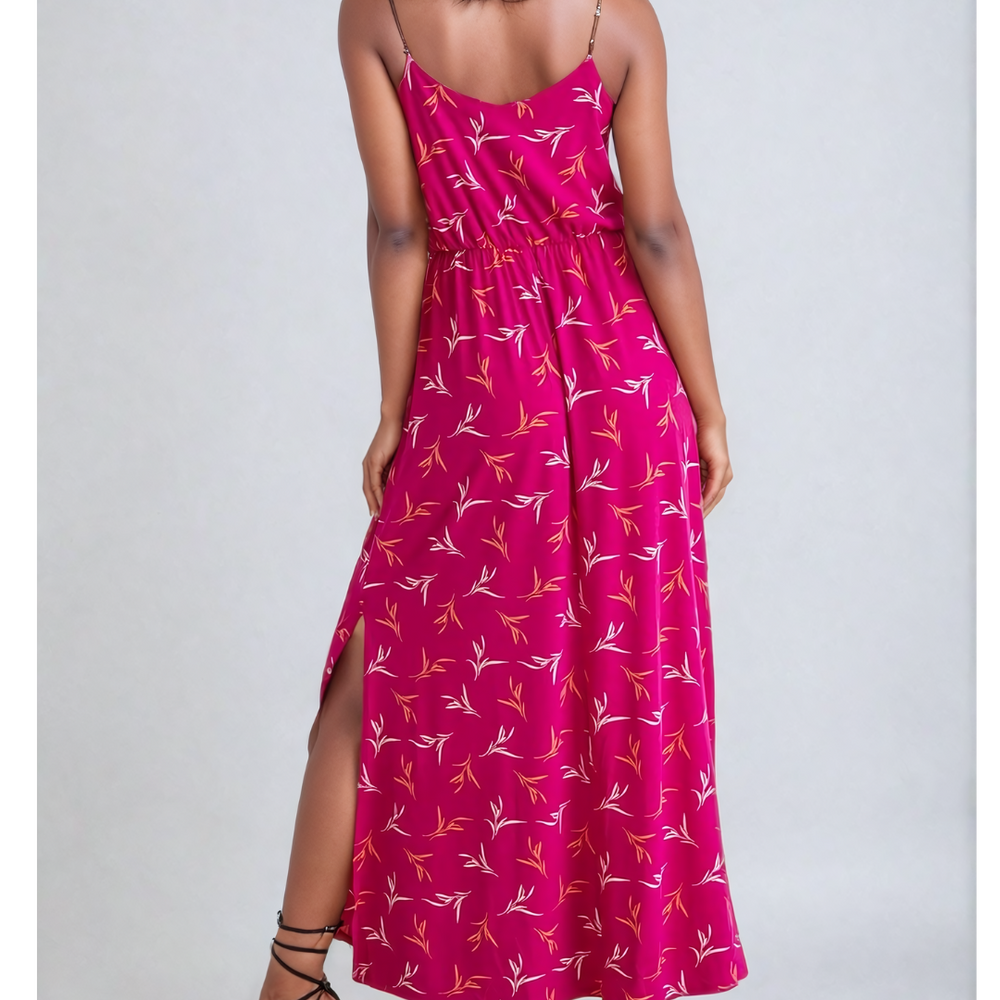 
                      
                        Image of a woman wearing a Fly Away Cami Maxi Dress in a vibrant floral print, suitable for various occasions, with adjustable straps and a flattering cami neckline.
                      
                    